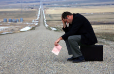 the photo shows a miserable job seeker with a pink 'end of employement' slip, worried as he doesn't know where his career path is going to take him next.